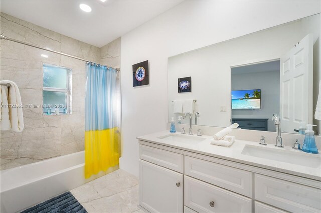 bathroom with shower / bathtub combination with curtain and vanity