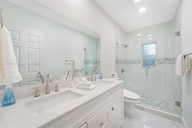 bathroom featuring toilet, a shower with door, and vanity