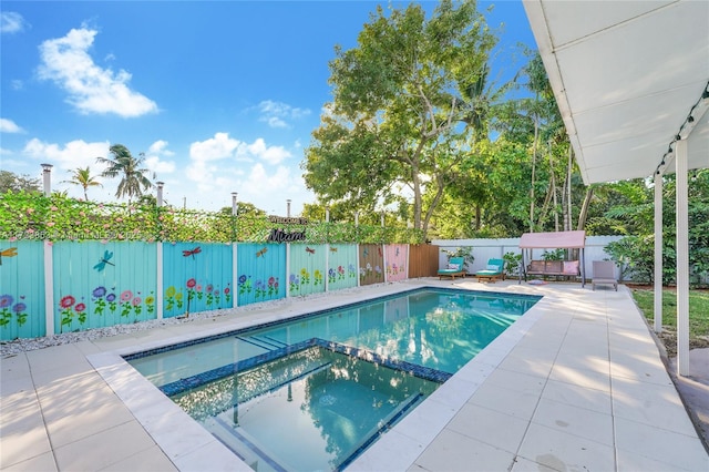 view of pool featuring an in ground hot tub and a patio