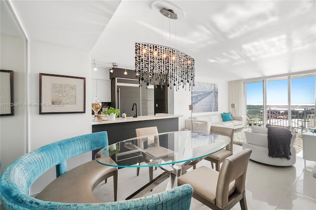 tiled dining room featuring expansive windows and a chandelier