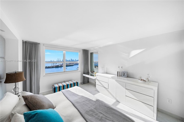 bedroom with radiator heating unit and a water view