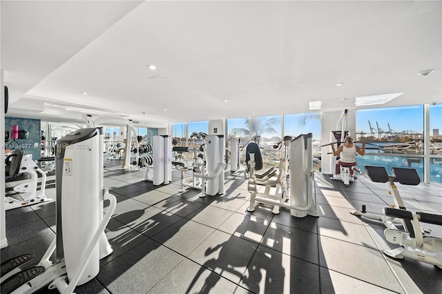 workout area with a water view, expansive windows, and plenty of natural light