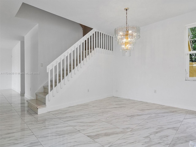 stairway featuring a notable chandelier