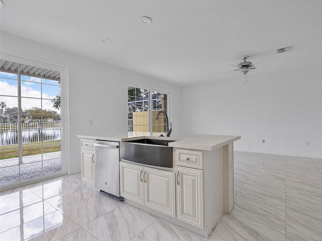 kitchen featuring sink, stainless steel dishwasher, ceiling fan, and a water view