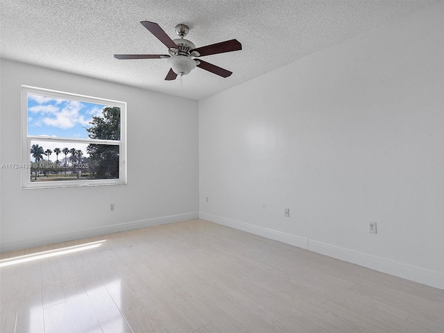 spare room with a textured ceiling, ceiling fan, and light wood-type flooring