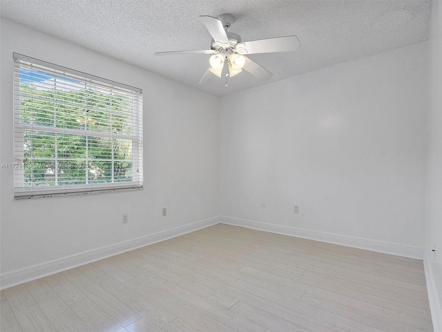 empty room with a textured ceiling and ceiling fan