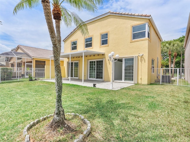 back of house featuring a lawn and a patio area