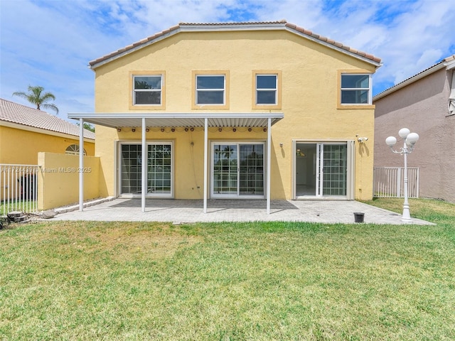 back of property featuring a patio and a yard