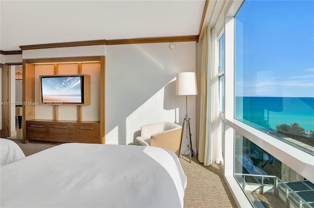 carpeted bedroom with ornamental molding