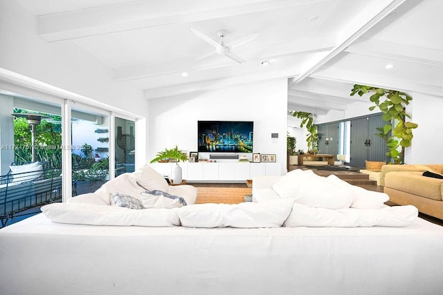 living room with ceiling fan, hardwood / wood-style floors, and lofted ceiling with beams