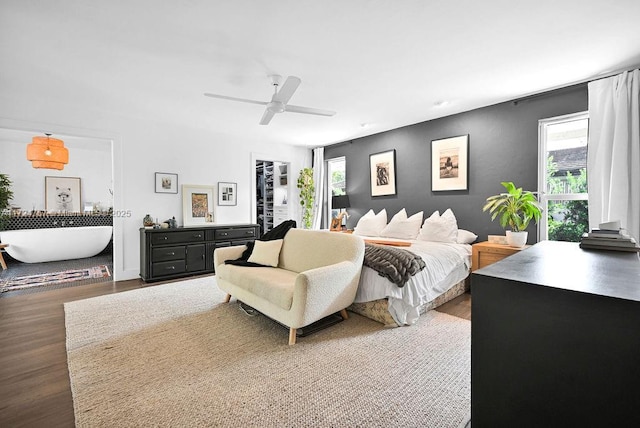 bedroom with multiple windows, ceiling fan, and dark hardwood / wood-style floors