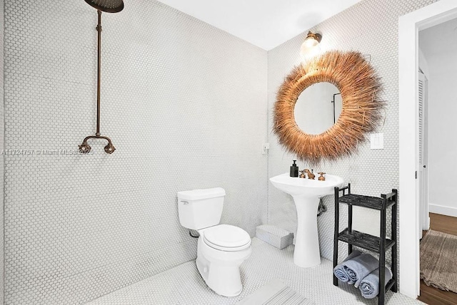 bathroom featuring sink, tile patterned flooring, and toilet