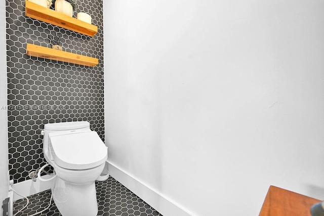 bathroom featuring toilet and tile patterned floors