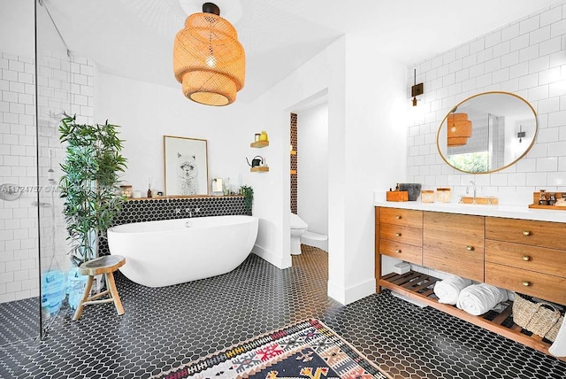 full bathroom with toilet, tile patterned floors, independent shower and bath, and vanity