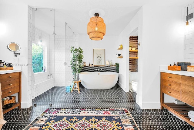 bathroom featuring toilet, plus walk in shower, and tile patterned floors