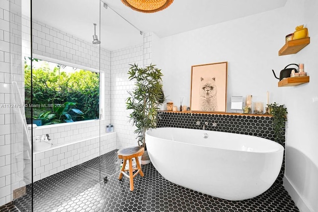 bathroom featuring tile patterned flooring and plus walk in shower