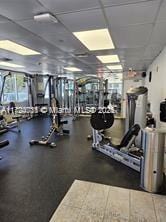 exercise room with a paneled ceiling