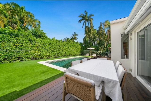 deck with a yard and a fenced in pool