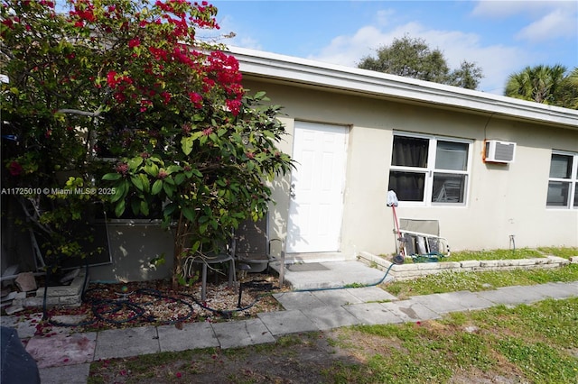 entrance to property with an AC wall unit