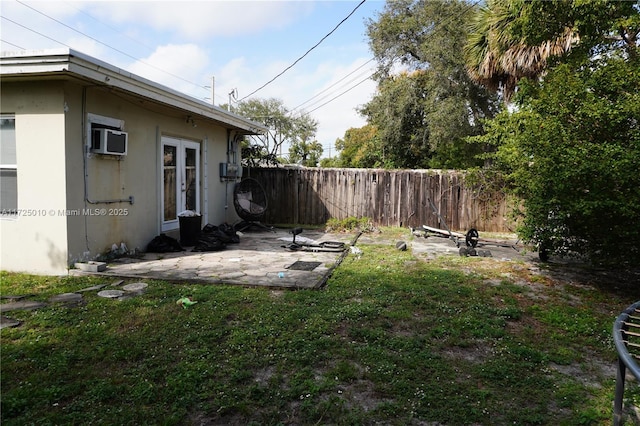 view of yard with a wall mounted AC and a patio area