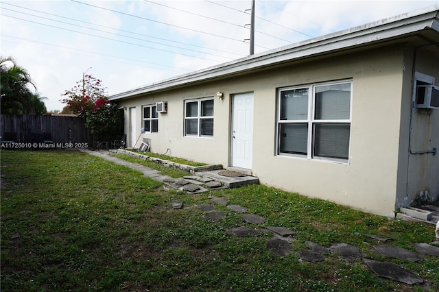 rear view of property featuring a yard