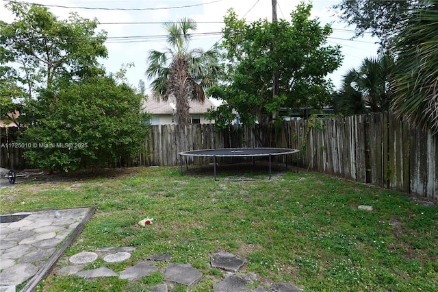 view of yard with a trampoline