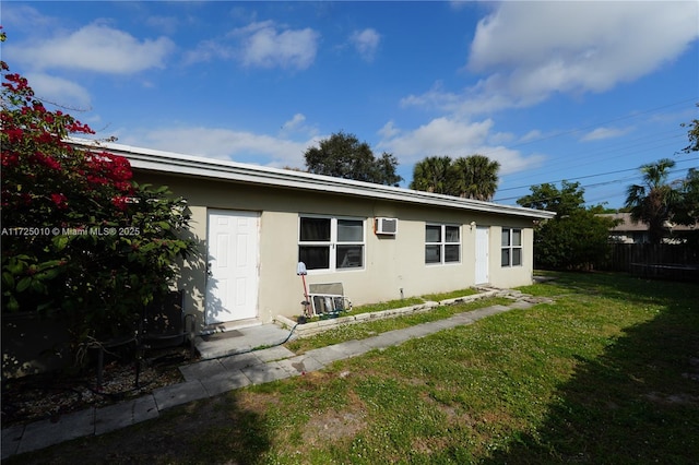 back of house featuring a yard