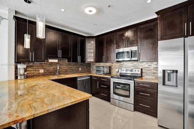 kitchen with decorative light fixtures, sink, dark brown cabinetry, and appliances with stainless steel finishes