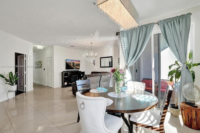 dining space with light tile patterned floors and a notable chandelier