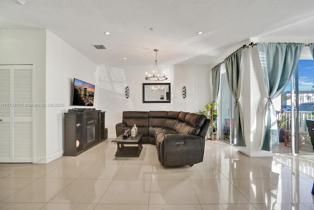 living room featuring light tile patterned floors and a chandelier