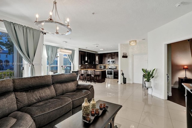 tiled living room featuring an inviting chandelier