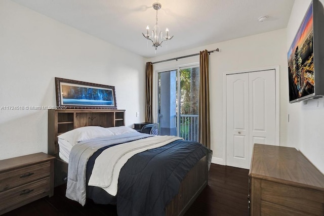 bedroom with a closet, dark hardwood / wood-style floors, access to exterior, and a notable chandelier