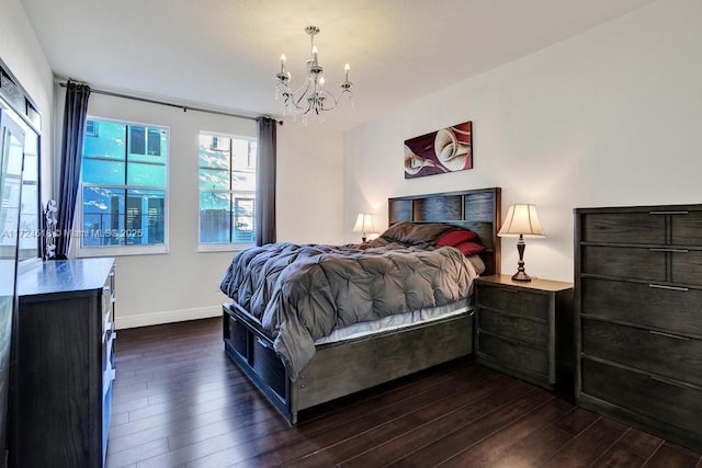 bedroom featuring dark hardwood / wood-style flooring and a chandelier