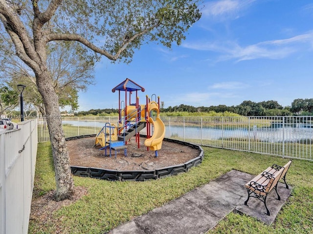 view of playground with a water view and a yard