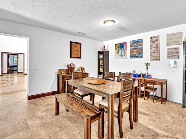 dining space with a textured ceiling