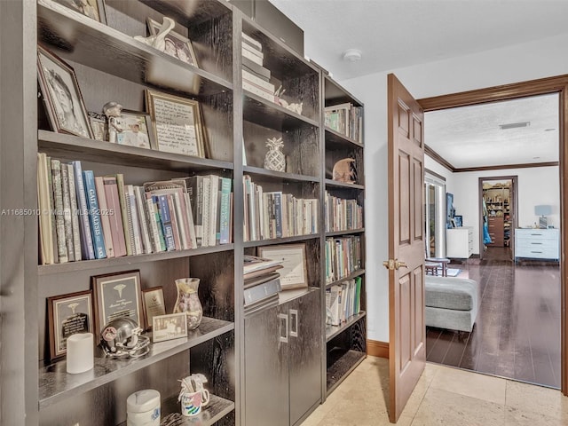 hallway featuring crown molding