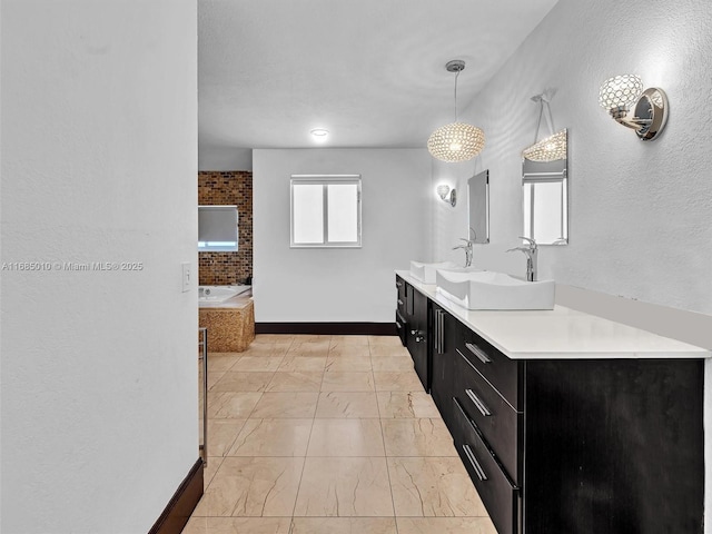 bathroom with vanity and a tub