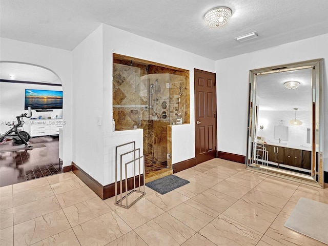 foyer featuring a textured ceiling