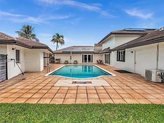 view of swimming pool with ac unit and a patio