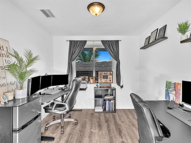 office area featuring a textured ceiling and hardwood / wood-style floors