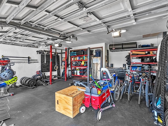 garage featuring a garage door opener and stainless steel refrigerator