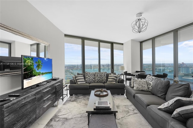 living room with a city view, a wall of windows, and an inviting chandelier