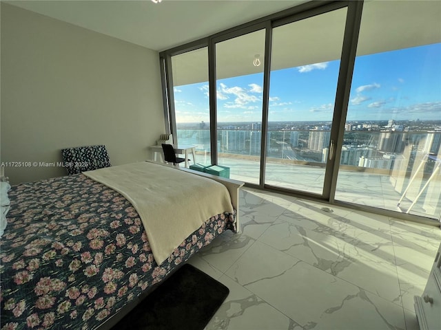 bedroom featuring access to exterior, expansive windows, and a water view