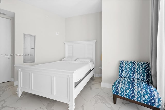 bedroom featuring marble finish floor, electric panel, and baseboards