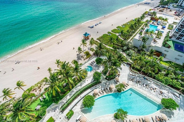 bird's eye view featuring a water view and a view of the beach