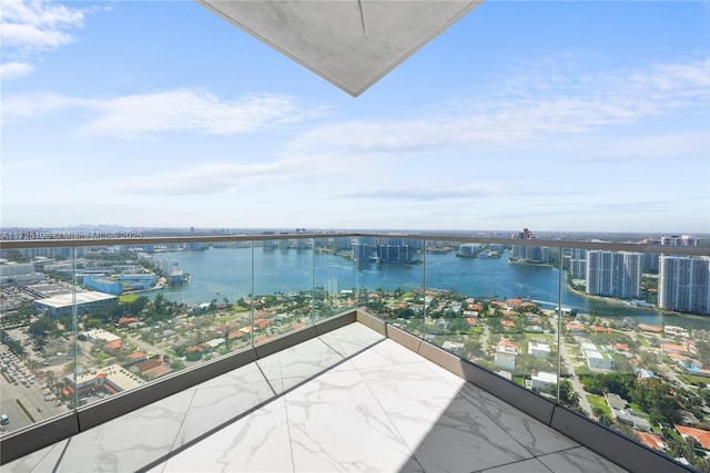 balcony featuring a view of city and a water view