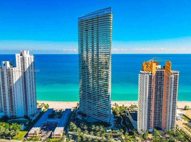 exterior space featuring a water view, a view of city, and a beach view