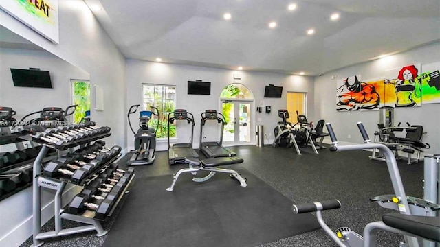 exercise room featuring french doors and vaulted ceiling