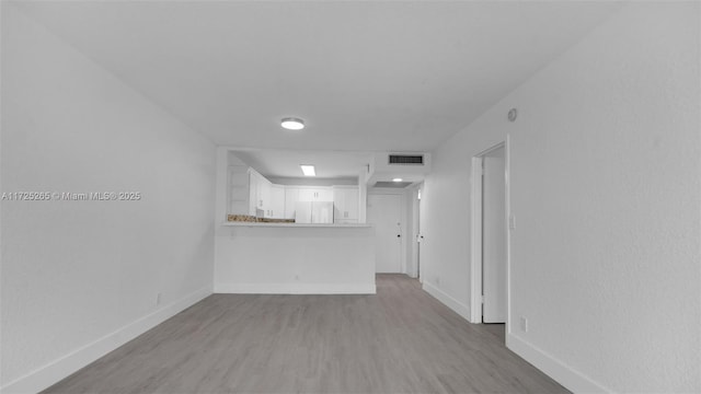 unfurnished living room featuring light hardwood / wood-style floors