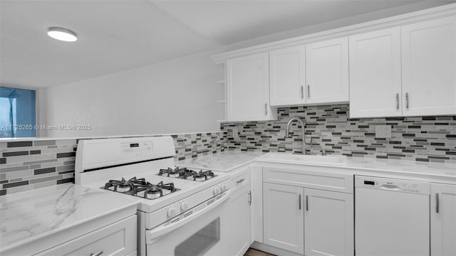 kitchen featuring white appliances, white cabinets, backsplash, and sink